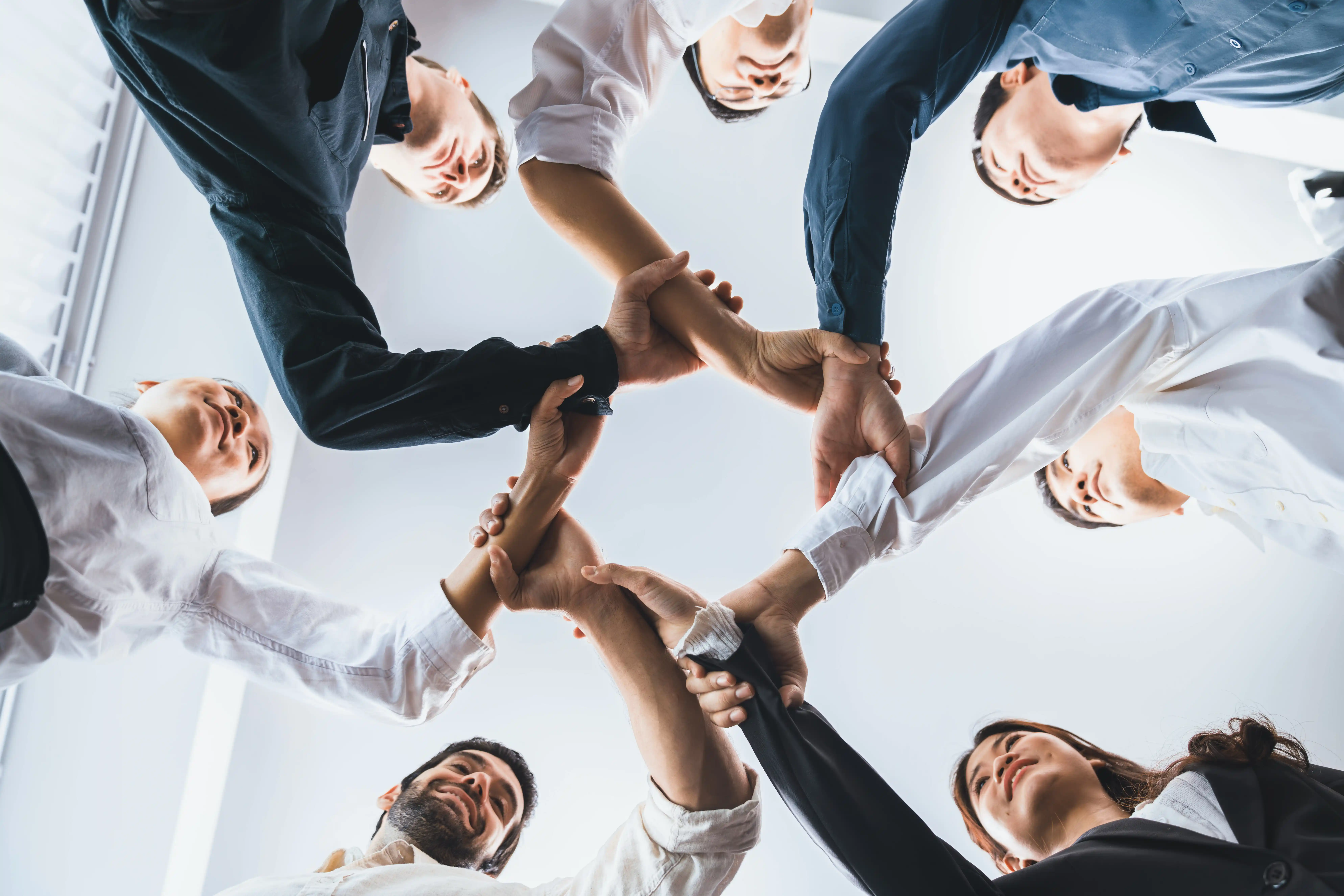 A diverse team of professionals collaborating in a modern office, showcasing Wispy Cloud Solutions' commitment to teamwork and success.